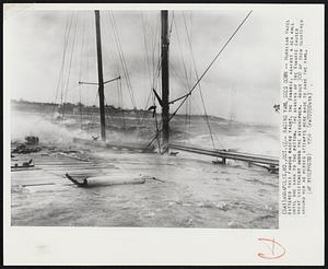 Racing Yawl Goes Down -- Hurricane Hazel battered this famous racing yacht, the Vamarie, against a sea wall until she sank to the bottom. The sinking of the Vamarie caused great excitement among the midshipmen. About 300 of them clustered around her as heroic attempts were made to save the yawl.