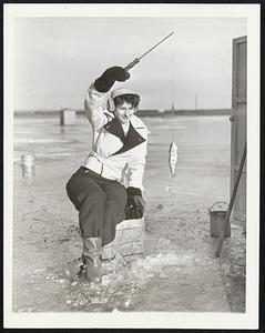 A Day With the Ice Fisherman. Toward noon, the weather warms up a bit and Ruth David decides to move the shanty away from the hole and fish out in the open. Her luck continues and she comes up with another good-sized perch.