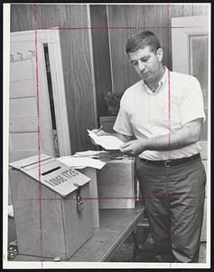 Ballot Checkoff-Thomas Gaffey, chief steward for Boston Local 1726 International Association of Machinists, checks vote tally following balloting on new contract Sunday. Contract was rejected 425-69.