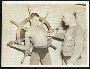 On the right is Ed Smith who played left end for Lew Manly the past season. Eddie hopes to become Coach Same Ruggeri's No. 1 representative in the 155-pound class. Coach Sam, on the right, thinks that Ed can get the rating if he keeps aturning the wheel.