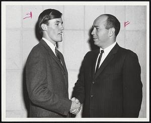 Mike Scanlon, cross country captain-elect for 1968 is congratulated by Northeastern coach Irwin Cohen.