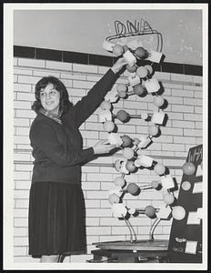 Public Latin School. Janet Amata (Amato) senior at Jeremiah E. Burke H.S. Dorchester prepares her "DNA" Exhibit