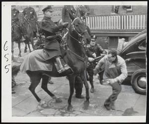 Fleeing Police -- An unidentified man flees police near Philadelphia General Electric Company plant where rioting broke out during demonstration of striking workers. Scores of mounted police spearheaded drive which broke up parade of workmen.