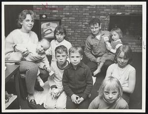 Family of Nine, the Watts family, were forced by the storm to evacuate their home at 146th Ave., Scituate. They were given refuge in the Knights of Columbus Building. From left: Mrs. Watts holding baby Patricia, 1, front row, Jimmy, 10, Stephen, 7, Susan, 8, Judy, 9. In rear: Cindy, 13, father, Charles, and Ann Marie, 3, in his lap.