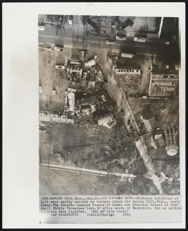 In Tornado Path--Business buildings at left were partly wrecked by tornado which hit Spring Hill, Tenn., early today. The tornado damaged dozens of homes and business houses in this small Middle Tennessee town, 30 miles south of Nashville. But no serious injuries were reported.