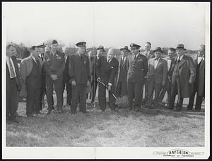 C. F. Adams, Jr., president of Raytheon Manufacturing Company, Waltham, Mass.,breaks ground for a new electronic laboratory to constructed at Hanscom Airfield, Bedford, Mass. Looking on are representatives of the armed forces, the Platt Contracting Company, the builders; Cleverdon, Varney and Pike, the engineers; and of Raytheon.
