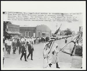 Klan Marches in Strength--Members of the Ku Klux Klan and their followers parade in strength through downtown Americus, Ga., today. The marchers held a brief prayer in front of a service station where Andrew A. Whatley Jr., a 21-year-old white man, was slain while Negroes demonstrated nearby.