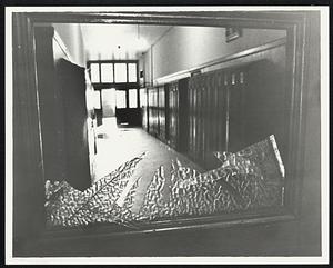 Smashed window overlooks empty corridor at English High School