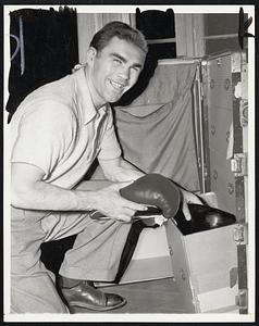 A Trunk-Full Of Dynamite Max Schmeling, his training ended, carefully packs his gloves in his trunk at speculator, N.Y., training headquarters June 20 as he prepared to leave for New York City to keep a date with Champion Joe Louis at Yankee Stadium June 22. The challenger was full of confidence, predicting he would again out-blast the bomber.