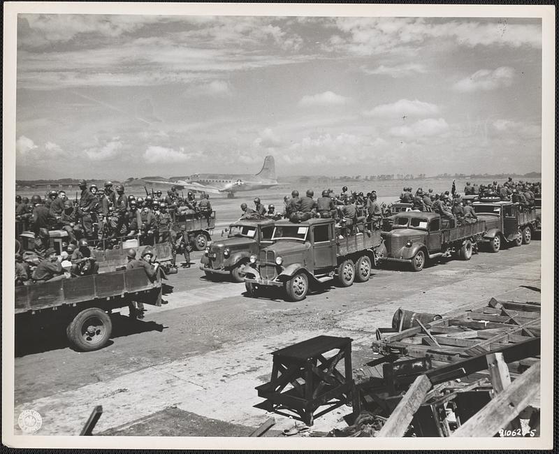 Elements of the 188th Parachute Infantry Regiment are loaded on trucks as fast as they unload from planes at Atsugi Airport, Japan