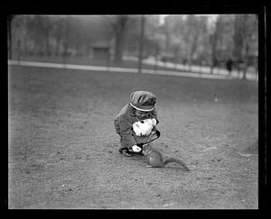 A girl feeding a squirrel