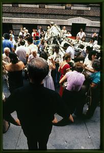 Boston 1981: A priest looks at a statue of St. Anthony carried through the N. End during St. Anthony's Feast in late August