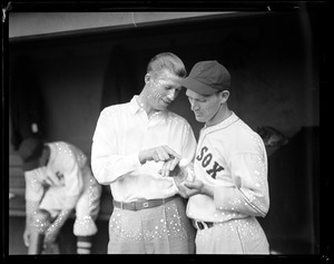 Lefty Grove shows off injured pinky to Fritz Ostermueller