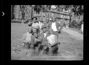 Eight young men posing in a park