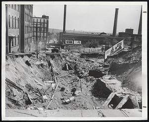 Could Have Been Worse-This washout broke up Jackson street in Holyoke. But Army Engineers pointed out that protective dikes there kept city from being inundated and averted much heavier damage.