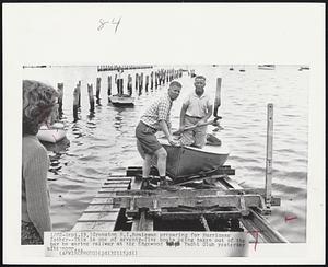 Boatsman preparing for Hurricane Esther -- This is one of seventy-five boats being taken out of the bay by marine railway at the Edgewood Yacht Club yesterday afternoon...