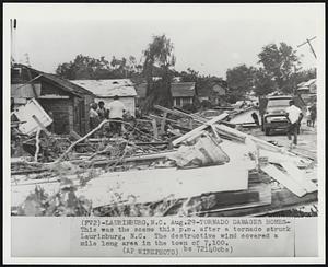 Tornado Damages Homes -- This was the scene this p.m. after a tornado struck Laurinburg, N.C. The destructive wind covered a mile long area in the town of 7,100.