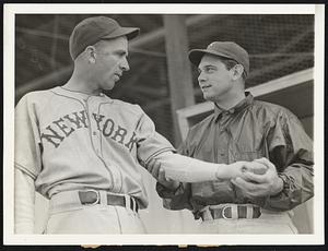 Terry Sizes up Hubbell. Bill Terry, manager of the New York Giants, counts on his pitchers to put his team back into the National League's first row this year, and he is here sounding the arm of veteran Carl Hubbell at first day's training at Winter Haven, Florida, February 24.
