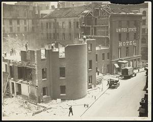 Another Boston landmark, once the finest hotel in the city, the United States Hotel, will soon Be only a memory, for workmen are now demolishing the building, as photo shows.