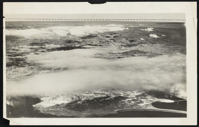 Columbus Was right, All Right. The camera is backing up Christopher Columbus in the matter of the earth's rotundity. Here is a photo taken from a naval plane flown by Lieut. T.R. Frederick at an elevation of 18,000 feet, showing a portion of the pacific coast country near San Diego. Calif., with a marked falling away of the horizon at the sides. The middle of the horizon in the picture is .03 of an inch higher then the ends.