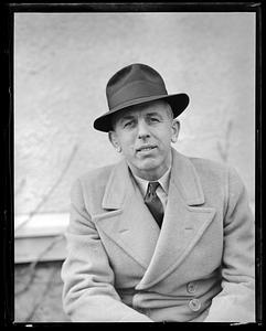 Unidentified man wearing a hat and coat