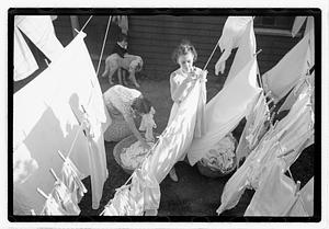 Women hanging laundry on clotheslines