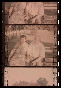 Two people seated on a bench