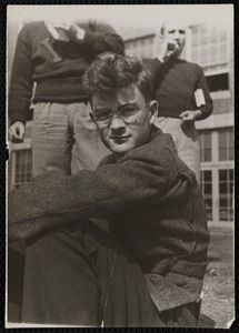 Young man seated on ground