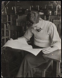 Young man with exam in classroom