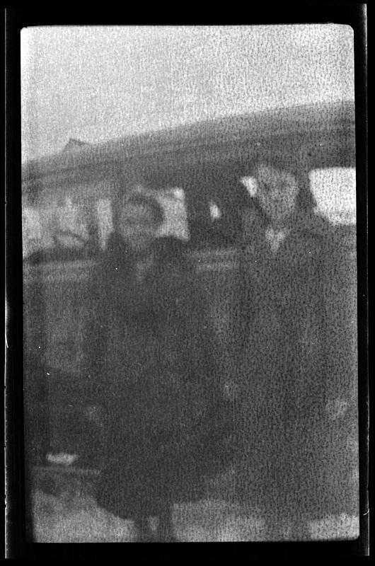 Two women stand next to a vehicle