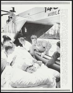 Bay St. Louis, Miss: An elderly, infirm patient from Hancock General Hospital is moved from an ambulance to a Coast Guard helicopter 8/18 to be airlifted to the U.S. Public Health Hospital in New Orleans. Power and water failure due to Hurricane Camille made the evacuation of the hospital’s 53 patients.