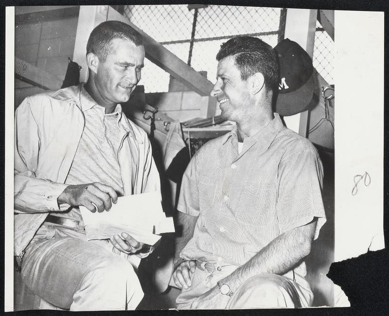 Braves Pitching hero Lew Burdette, left, and outfielder Andy Pafko check their fan mail as they arrive in the Milwaukee clubhouse for today's game.