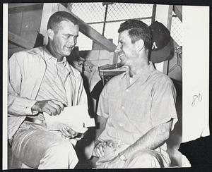 Braves Pitching hero Lew Burdette, left, and outfielder Andy Pafko check their fan mail as they arrive in the Milwaukee clubhouse for today's game.