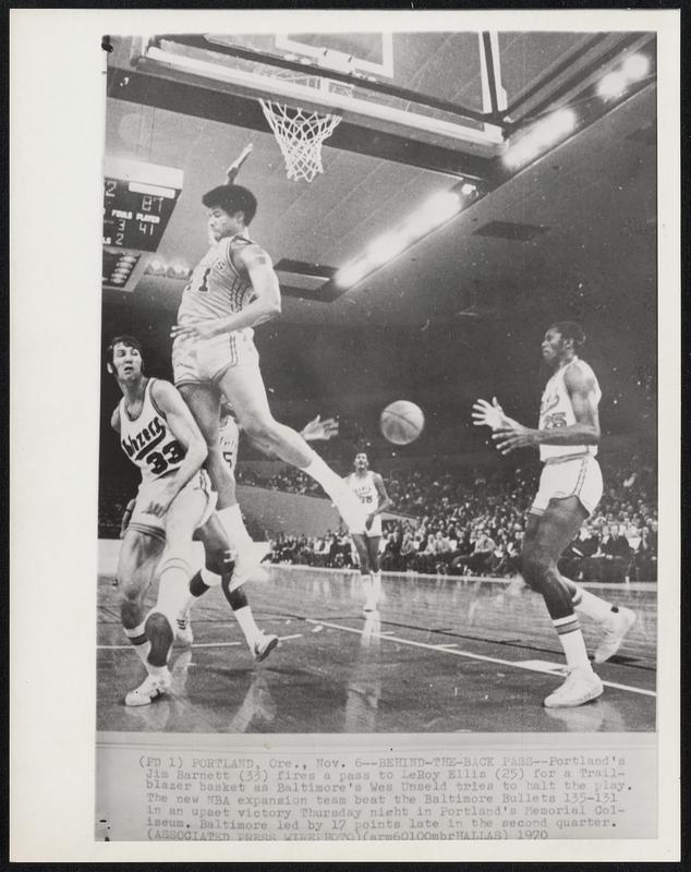 Behind-The-Back Pass--Portland's Jim Barnett (33) fires a pass to LeRoy Ellis (25) for a Trailblazer basket as Baltimore's Wes Unseld tries to halt the play. The new NBA expansion team beat the Baltimore Bullets 135-131 in an upset victory Thursday night in Portland's Memorial Coliseum. Baltimore led by 17 points late in the second quarter.