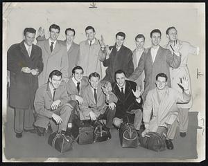 As Holy Cross Departed for New York and the start of their defense of their N.C.A.A. basketball championship. This is the full squad, with the exception of Coach Alvin "Doggie" Julian, as it left Worcester this morning. Front row, left to right, are Dennis O'Shea, George Kaftan, Joe Mullaney, Bob McMullan, and Andy Laska. Back row are Mascot Bill "Rocks" Gallagher, Frank Oftring, Charley Graver, Capt. Bob Curran, Dermie O'Connell, Bert Dolan, Bob Cousy and Matt Forman.
