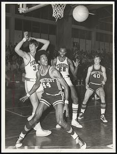 Battle for Ball-Jim Hayes (32) and Tom Taylor (22) of BU and Bob Taylor (44) and Tom McCrockun (40) of Connecticut move in for rebound.