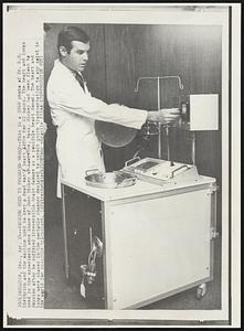 Machine Used to Preserve Heart--This is a 1968 photo of Dr. E.B. Diethrich and the machine used to keep a dead man's heart alive for 22 hours. The heart and lungs used in the experiment where those of John Hickey of Lawrence, Mass. Hickey had been flown to Houston after he suffered irreversible brain damage as a possible heart donor. The heart and lungs were placed in the portable chamber designed to permit quick transportation to any point in the world for possible transplant.