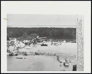 Isolated Chincoteague-A Navy helicopter rescues a resident of Chincoteague today from the storm-ravaged island. Helicopters have removed more than 1,000 persons from the island, which was devastated by Wednesday's storm.