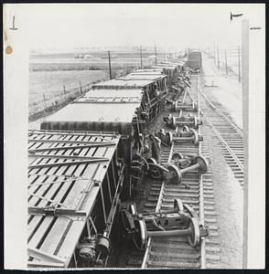 Toppled By Wind – These seven boxcars are part of a string of 13 cars of a Union Pacific freight train toppled yesterday at Kaysville, Utah, by a high wind. The main line tracks were blocked for several hours.