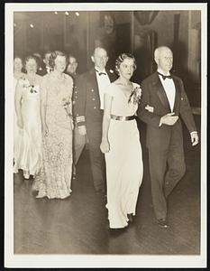 Secretary Adams Leads Grand March. Accompanied by Miss Margaret Young of Washington, D.C., the Secretary of the Navy Charles Francis Adams Heads the Line at Farewell Ball at Washington, D.C., Navy Yard in Honor of Famous Old Fighting Frigate, Constitution, Which Leaves Soon for Exhibition Tour of West Coast Ports. Behind Them are Mrs. H.S. Morgan, a Daughter of Mr. Adams, Accompanied by Commander Louis J. Gulliver, Skipper of the Constitution.