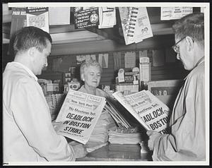 Commuters at South Station, Boston, purchase copies of a special Boston edition of the New York post on sale here to fill gap caused by strike on six of seven Boston daily papers. The New York paper featured four pages of Boston news, The newspaper blackout started five days ago with a walkout of 1,150 printers.