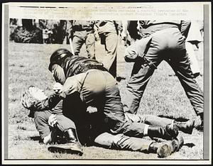 A Madison policeman restrains a youthful protester at the University of Wisconsin 5/5 during a demonstration against President Nixon's Cambodian policy.