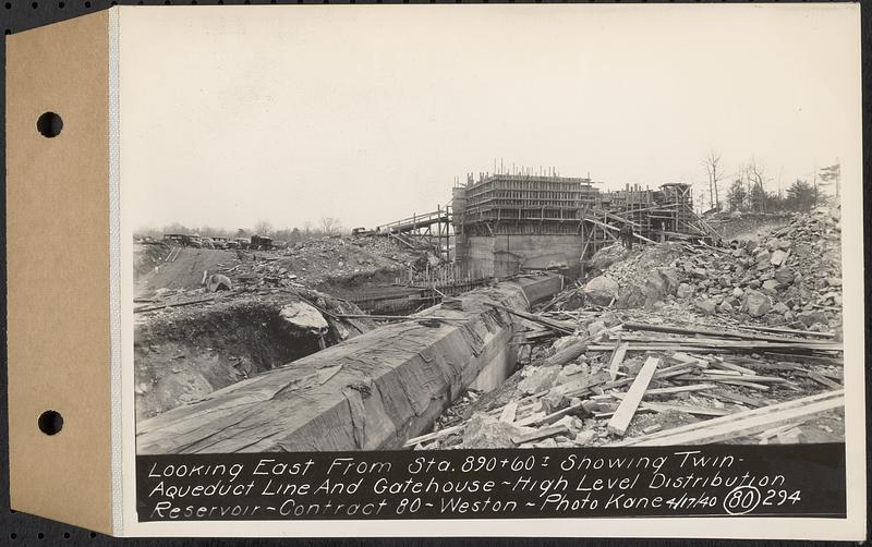 Contract No. 80, High Level Distribution Reservoir, Weston, looking east from Sta. 890+60+/- showing twin aqueduct line and gatehouse, high level distribution reservoir, Weston, Mass., Apr. 17, 1940