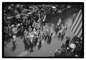 People walking in a rainy parade