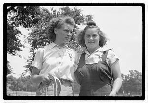Two young women holding horseshoes