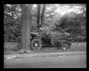 Wrecked car which has hit a tree