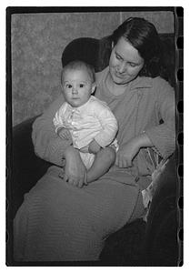 Maude Sanromá holding a baby