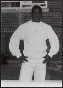Young man wearing white sweatshirt with hands on hips