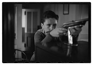 Boy with a toy gun on a ship