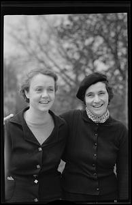Two women smiling, arm in arm